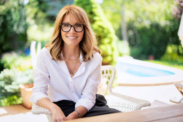 Portrait Happy Middle Aged Woman Sitting Lounge Chair While Relaxing — Stockfoto