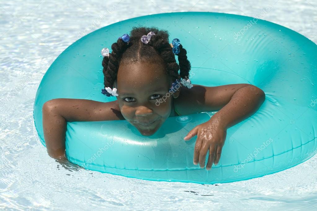 young black girl playing in swimming pool