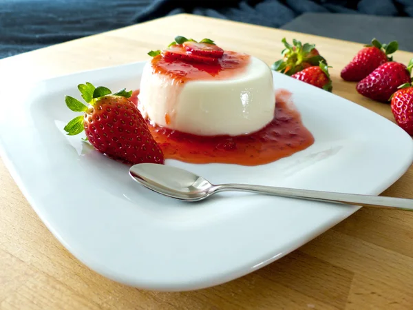Panna cotta on a plate and wood — Stock Photo, Image
