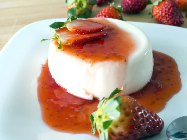 Panna cotta on a plate and wood — Stock Photo, Image