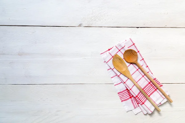 Kitchen towel background with wooden spoons — Stock Photo, Image