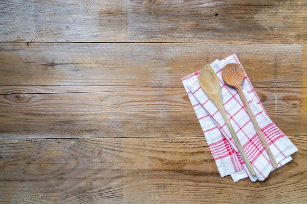 Kitchen towel background with wooden spoons — Stock Photo, Image