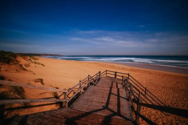 The idyllic Number Sixteen Beach and moon rising at sunset in Rye, Victoria, Australia