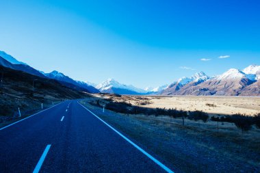 The Highway 80 road towards Mt Cook Village along Lake Pukaki on a clear spring day in Canterbury, New Zealand