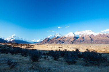 The Highway 80 road towards Mt Cook Village along Lake Pukaki on a clear spring day in Canterbury, New Zealand