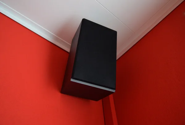 Musical speaker column on a red wall ceiling. — Stock Photo, Image