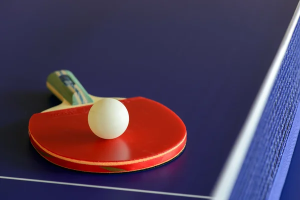 Racket and ball on table- tennis table