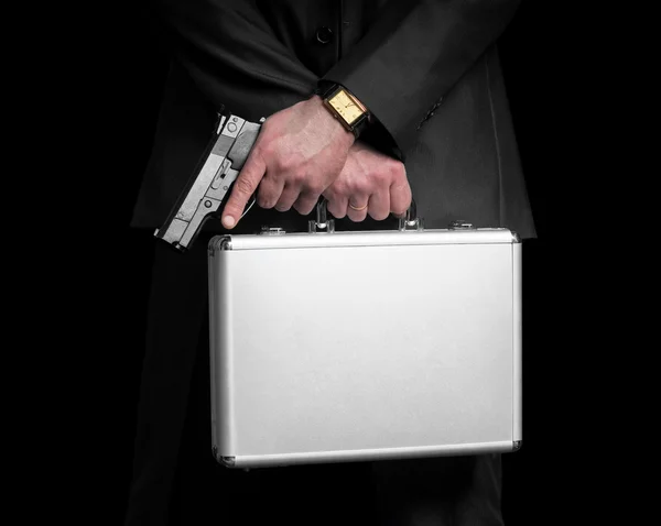 Businessman with gun and silver metal briefcase. — Stock Photo, Image