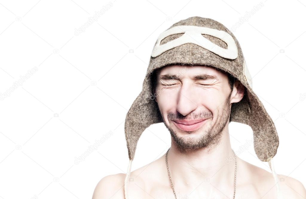 Attractive man portrait resting in russian bath with hat on head.