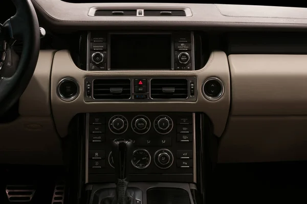 Modern car inside. Multimedia screen and control buttons.