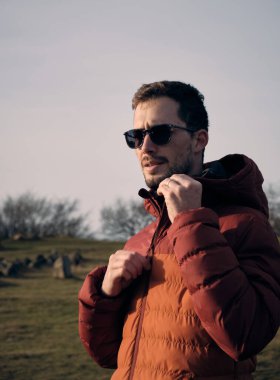 portrait of a handsome man in the ancient viking Lindholm Hoje graveyard, Aalborg, North Juntland, Denmark