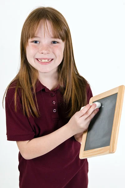 Young girl writing on chalk board — Stock Photo, Image