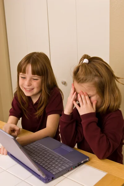 Two young girls working on a laptop computer — Stock Photo, Image
