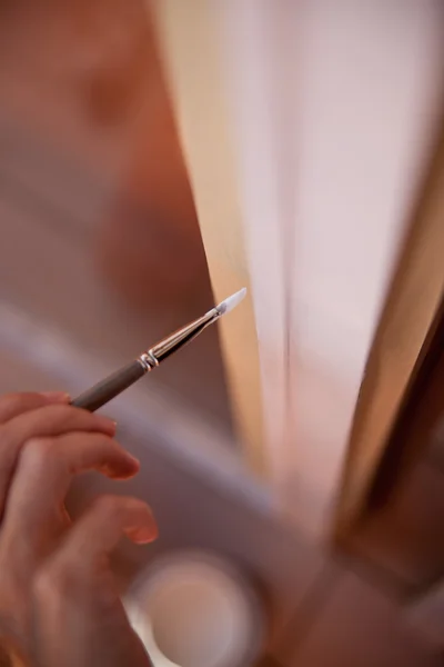 Hands of a girl painting a window — Stock Photo, Image