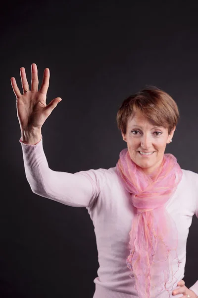 Mature woman with a raised hand — Stock Photo, Image