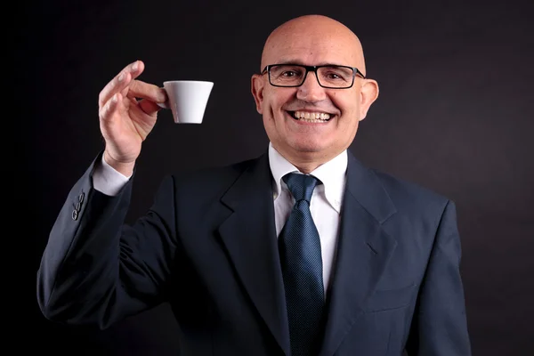 Old businessman with a cup of coffee — Stock Photo, Image