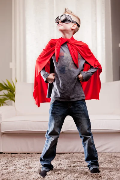 Red cloak  kid livingroom superhero — Stock Photo, Image