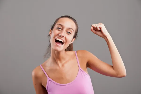 stock image winning girl raising up her arm happily