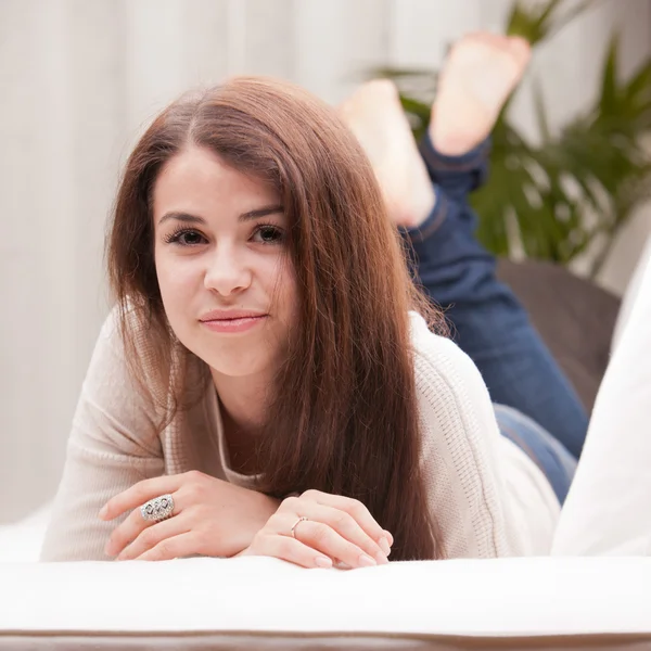 Self confident beautiful young girl on a couch — Stock Photo, Image