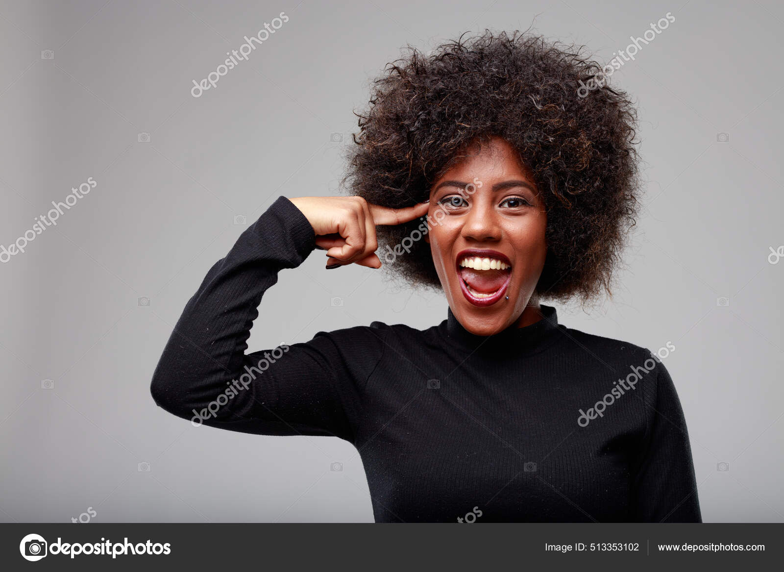 Mischievous Trendy Young Black Woman Pointing Her Temple Mischievous Grin  Stock Photo by ©Giulio_Fornasar 513353102