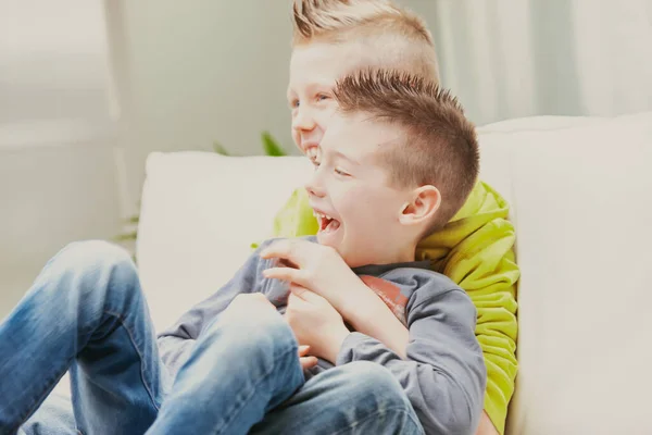 Two Fun Loving Young Brothers Cuddling Laughing Together Sofa High — Stock Photo, Image