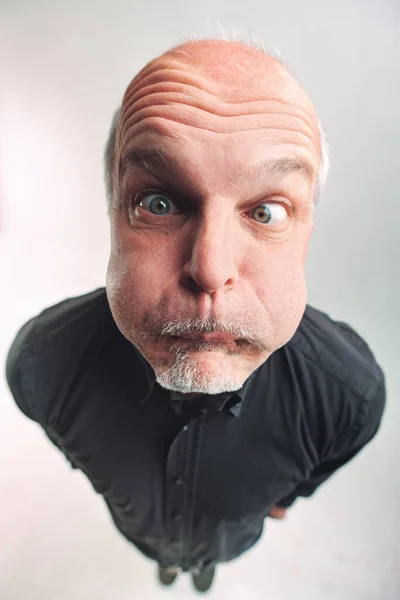 Senior Man Pulling Funny Comic Face Top View Looks Camera — Stock Photo, Image