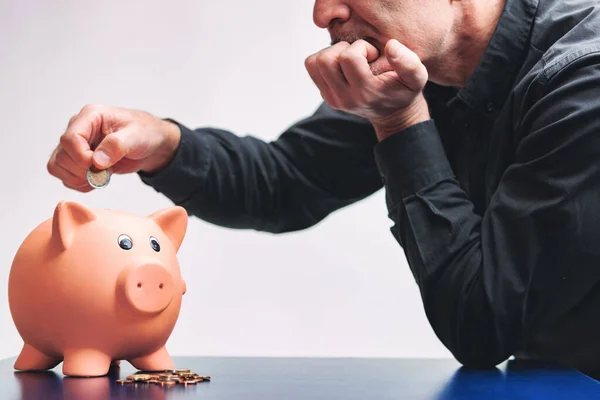 Man Slowly Adding Coins His Piggy Bank His Chin Resting — Stock Photo, Image