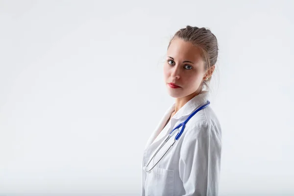 Young Sweet Doctor Looks Slight Gentle Reassuring Smile She Serious — Stock Photo, Image