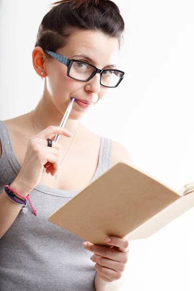 Thoughtful Woman Wearing Glasses Holding Journal Pen Her Lips Looking — Stock Photo, Image