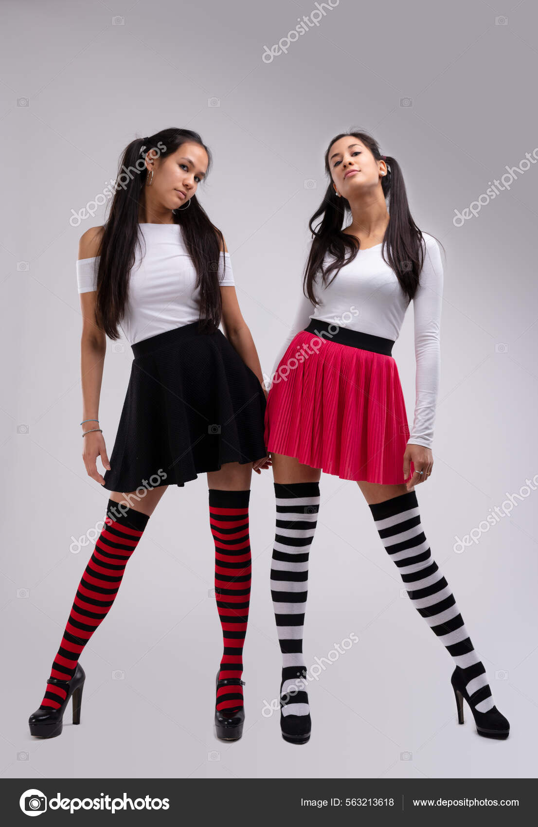 Two Young Girl Fashion Models Striped Leggings Black Red Skirts.