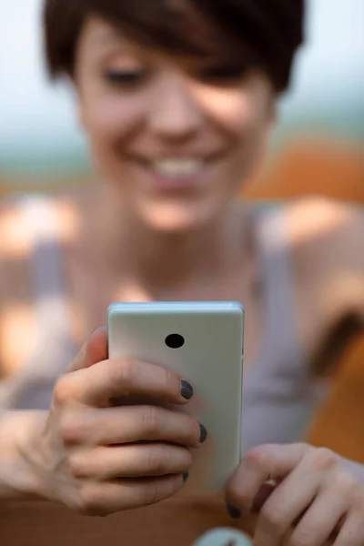 Young Woman Reading Message Her Mobile Smile Close View Selective — Foto Stock