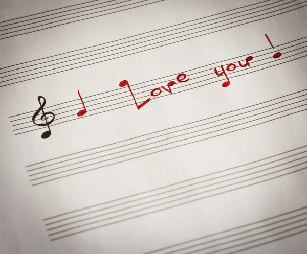 Words "I love you !" in shape of music notes in the music note book — Zdjęcie stockowe