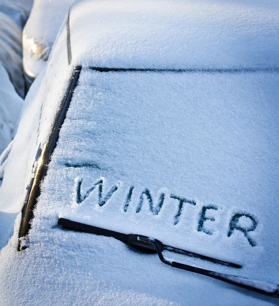 Winter written in snow on car windscreen below windscreen wiper — Stock Photo, Image