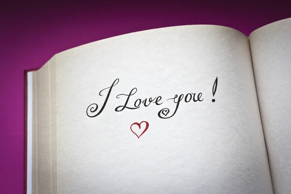 I love you words in the open book with pink background and copy space for your text. Concept for declaration of love. Also good for postcard. — Stock Photo, Image