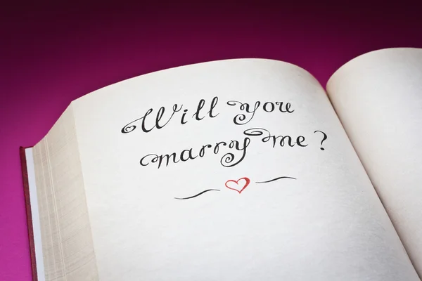 ¿Te casarás conmigo? palabras y corazón rojo en el libro abierto. Creado con amor . —  Fotos de Stock