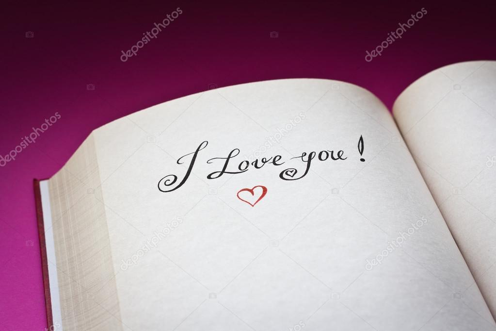 I love you words in the open book with pink background. Concept for declaration of love.Also good for postcard.