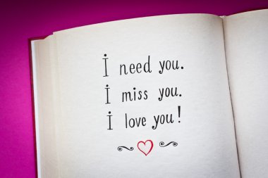 Hand drawn words I need you, I miss you, I love you in the open book with color background