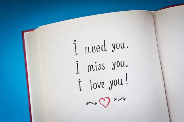 Hand drawn words I need you, I miss you, I love you in the open book with color background — Stock Photo, Image