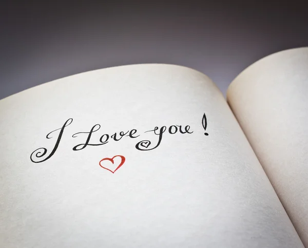 I love you words in the open book with grey background. Concept for declaration of love.Also good for postcard. — Stock Photo, Image