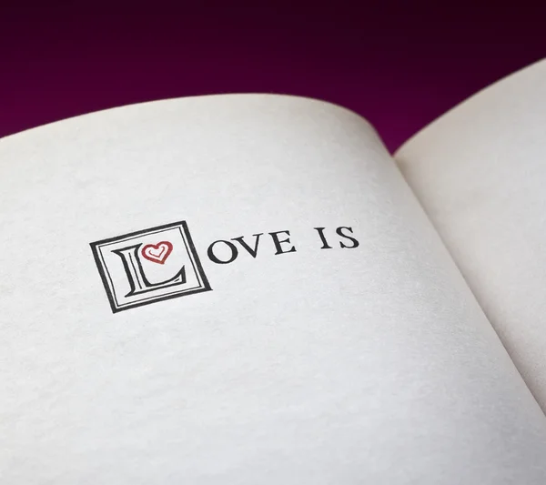 Words Love is in the open book. With space for your text what love is. — Stock Photo, Image