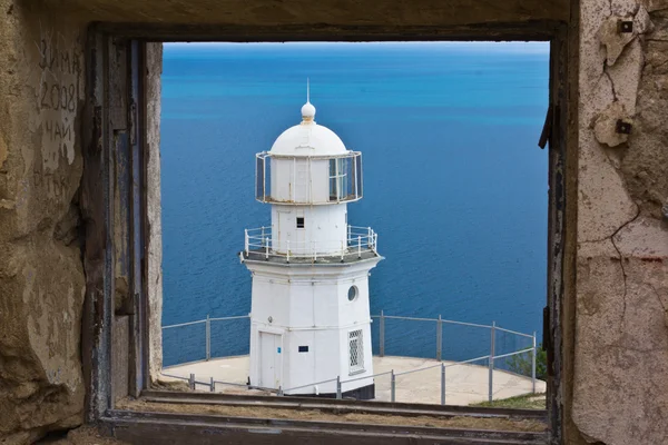 Old lighthouse against blue sky in Crimea, Ukraine — Stock Photo, Image