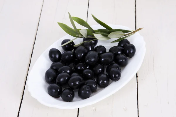 Zwarte olijven in witte plaat — Stockfoto
