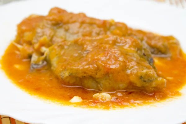 Pieces of cod with tomato on plate — Stock Photo, Image