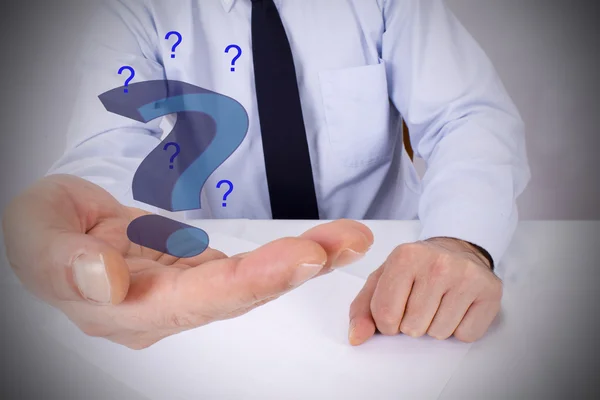 Businessman with question marks on hand — Stock Photo, Image