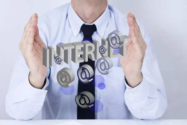 Businessman in office with computer terms — Stock Photo, Image