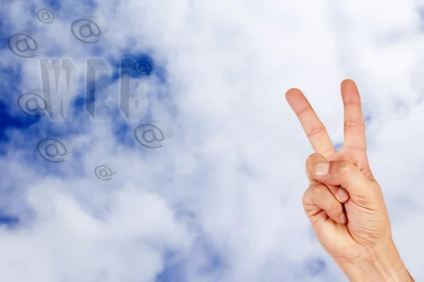 Hand in the clouds with words internet — Stock Photo, Image