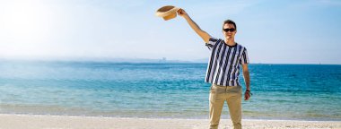 Kumsalda yürüyen rahat ve mutlu bir adam.