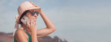 Mobil telefonda konuşurken şapkalı kadın