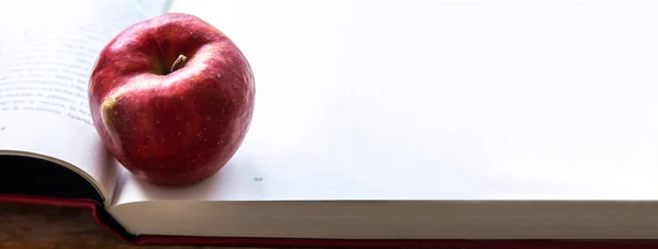 back to school concept. book with apple on the table