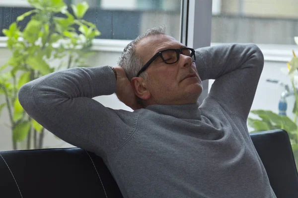 mature man relaxed on the sofa at home